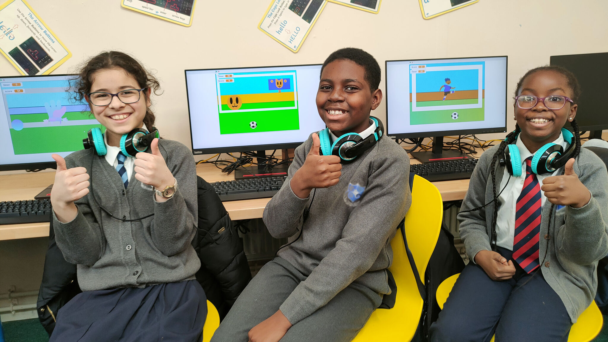 Students showing off their coding projects with big smiles